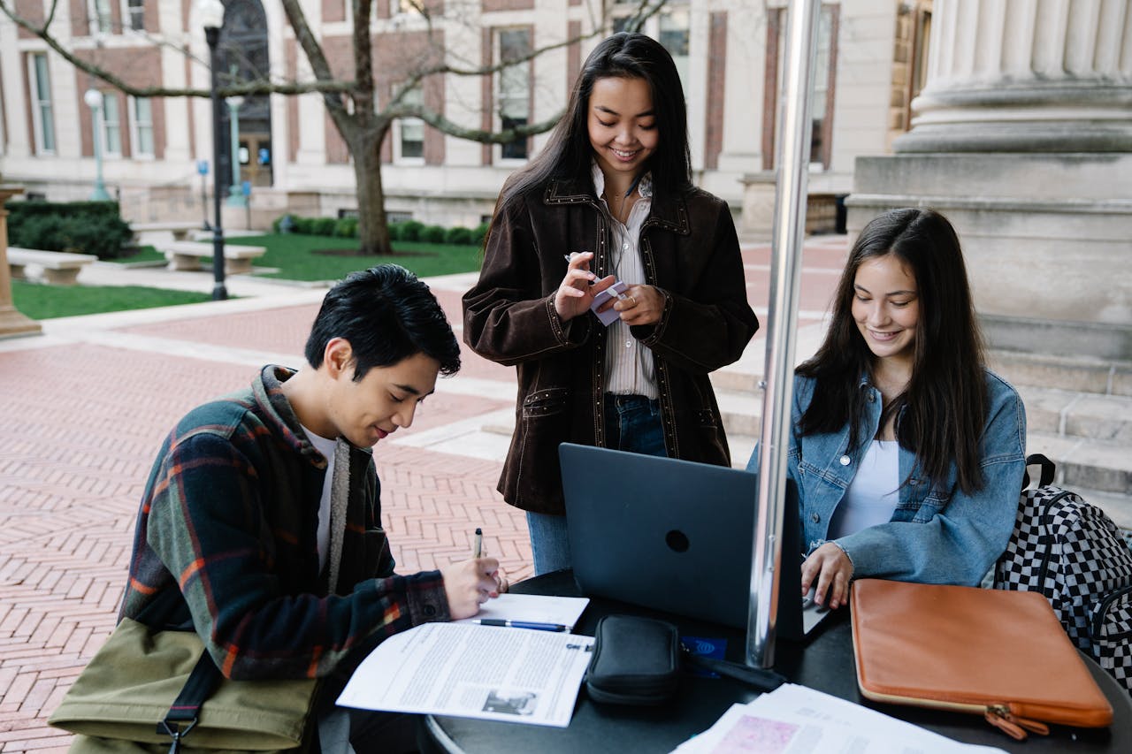 Financial aid staff helping a student review college costs. Photo by George Pak on Pexels.com.